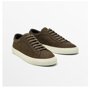Three pairs of sneakers in beige, brown, and dark brown on a white background.