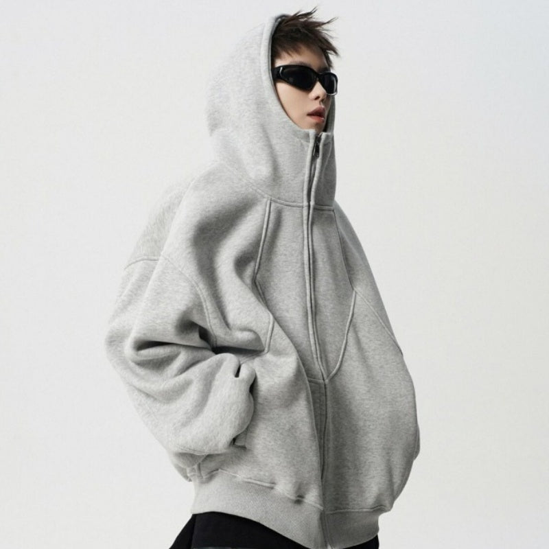 Person wearing a gray hoodie with a white background