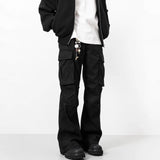 Person wearing black cargo pants on a white background