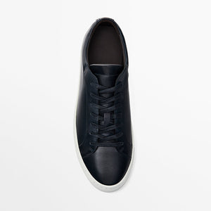 Black leather sneaker on a white background