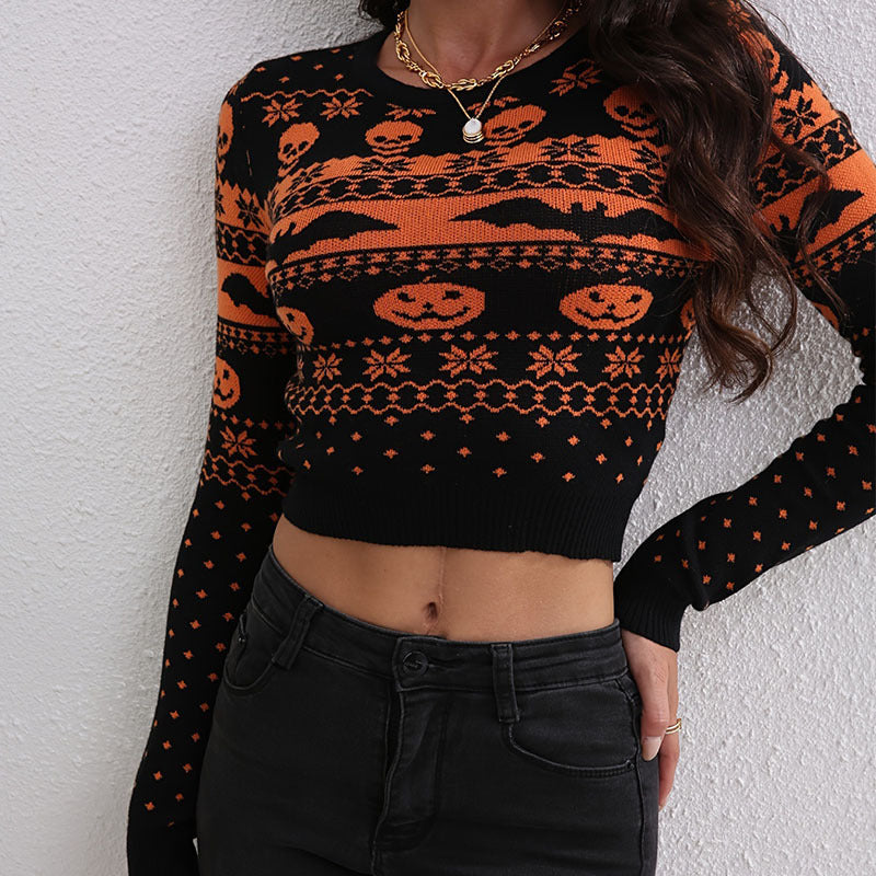 Person wearing a black and orange Halloween-themed sweater against a white wall.
