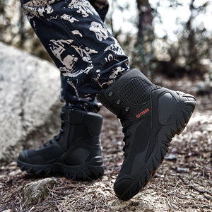 Black outdoor boots worn in a natural setting with trees and rocks.