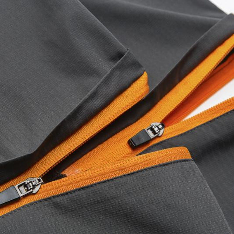 Close-up of a gray jacket with an orange zipper