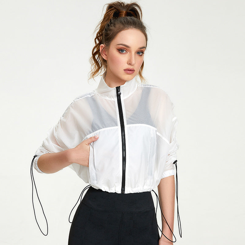 Woman wearing a white sheer jacket with black accents on a white background