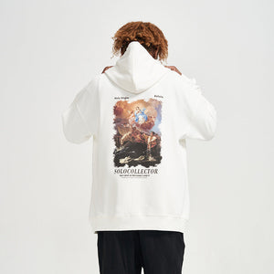 Person wearing a white hoodie with a graphic design on the back, standing against a plain background