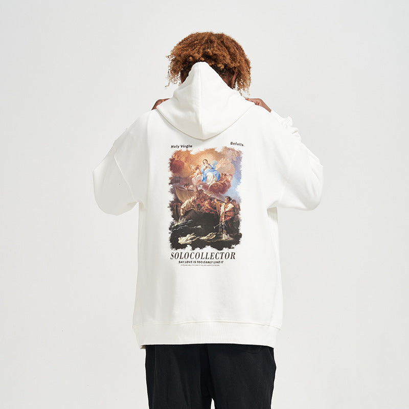 Person wearing a white hoodie with a graphic design on the back, standing against a plain background