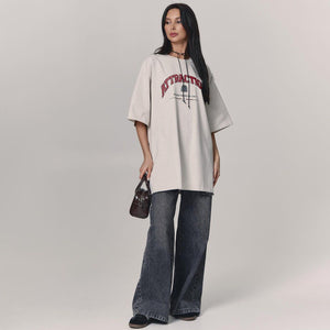 Letter T-Shirt - Loose Shoulder Printed Top - MRC STORET-ShirtsMy StoreWoman wearing a beige oversized t-shirt with text and dark jeans on a plain backgroundMRC STORECJCS204529003CXGray And WhiteL