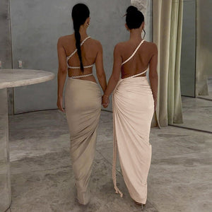 One - Shoulder Dress - Backless Ruched Long - MRC STOREDressMy StoreTwo women in matching beige dresses walking together in a modern interior setting.MRC STORECJLY242112303CXApricotL