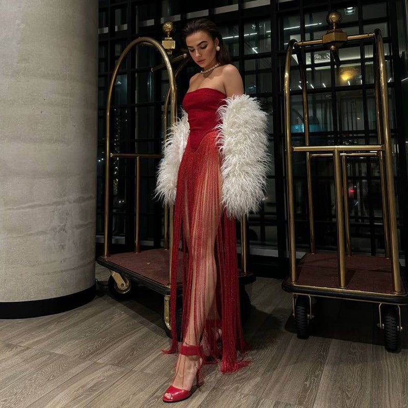 Women’s Tube Top Tassel Dress - MRC STOREDressMy StoreWoman in a red dress with a white fur stole standing between two gold luggage carts.MRC STORECJLY249066908HSRedL